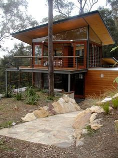 the house is surrounded by trees and rocks