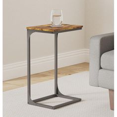 the end table is made from metal and has a wooden top with a glass on it