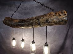 five mason jar lights hanging from a log