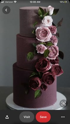 a three tiered cake with pink flowers on top