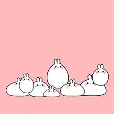 a group of rabbits standing next to each other on a pink background