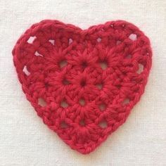 a red crocheted heart on a white background