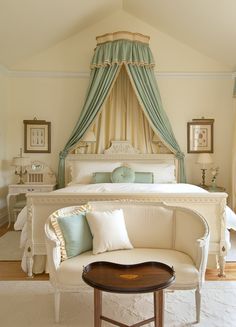 a bedroom with a white bed and blue drapes