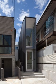 the house is made up of two different types of buildings and has glass windows on each side