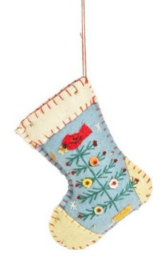 a christmas stocking hanging on a string with a bird and flowers design in it