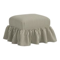 a black and white striped ottoman with ruffles on the bottom, sitting in front of a white background