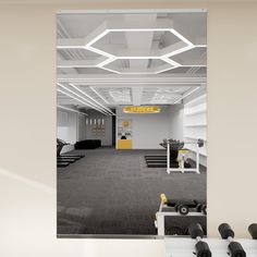 an empty gym with rows of exercise equipment in the foreground and on the far wall