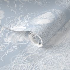 the wallpaper is white and has an intricate design on it, as well as a light blue background