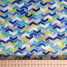 a ruler is next to a blue and green fabric