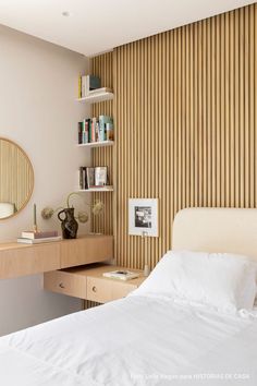 a bedroom with a bed, desk and bookshelf on the wall next to it