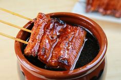 there are some ribs on sticks in a pot