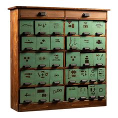 a wooden cabinet filled with lots of green boxes