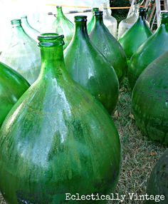 many green vases are sitting in the grass