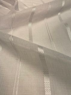 an image of white fabric with lines on the bottom and sides that appear to be woven