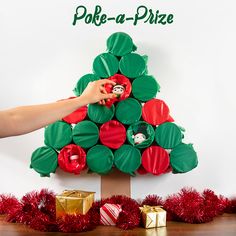 a paper plate christmas tree made to look like it is being held by someone's hand