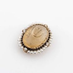 For Sale on 1stDibs - Large carved citrine cameo pin. Frame is 18K rose gold holding 28 seed pearls and four (4) round diamonds totaling 0.50 carats. Measures 1-5/16' long, Luxury Oval Cabochon Brooches, Elegant Yellow Gold Baroque Brooches, Elegant Intaglio Brooches For Gifts, Luxury Yellow Gold Cameo Brooch, Luxury Yellow Gold Cabochon Brooches, Elegant Formal Brooch With Intaglio Detail, Elegant Oval Intaglio Brooches, Elegant Gold Intaglio Brooches, Elegant Intaglio Brooch For Formal Occasions