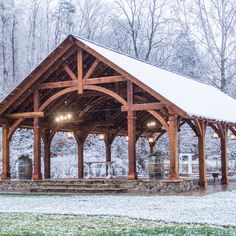 a wooden pavilion with snow on the ground