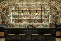 the bar is decorated with tropical wallpaper