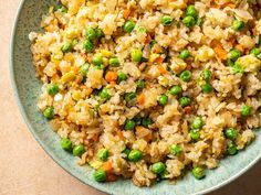 a bowl filled with rice and peas on top of a table