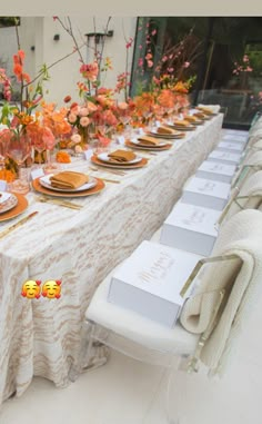 an image of a table set up with flowers and place settings on it for dinner