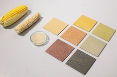 corn on the cob next to several different colored tiles