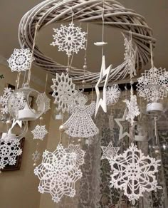 white snowflakes hanging from a wicker chandelier