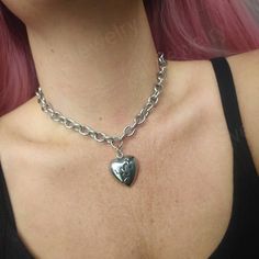 Stunning gothic/punk style chunky broken heart choker necklace in silver 💔  Chunky yet lightweight and comfortable to wear this necklace goes well with any outfit! This necklace is made of 100% stainless Steel so is water resistant and won't tarnish or discolour! Available in various sizes ( necklace shown in photographs measures 15 inches) Width of chain: 12mm Heart pendant measures: 29x26mm Please don't hesitate to contact me with any queries or suggestions 😊  Comes gift wrapped 🖤 Metal Heart Charm Choker Necklace, Emo Heart Pendant Metal Necklaces, Punk Style Heart Pendant Jewelry With Heart Charm, Punk Style Metal Necklace With Heart Pendant, Punk Style Metal Heart Pendant Necklace, Emo Heart Pendant Metal Necklace, Edgy Silver Heart-shaped Necklace, Punk Metal Heart Necklace For Valentine's Day, Punk Style Metal Heart Necklace For Valentine's Day