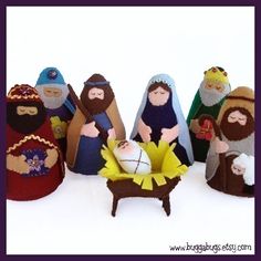 a group of nativity figurines sitting next to each other