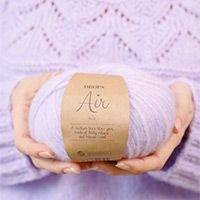 a woman holding a ball of yarn in her hands with the word air written on it