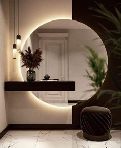 a bathroom with a round mirror on the wall and a plant in front of it