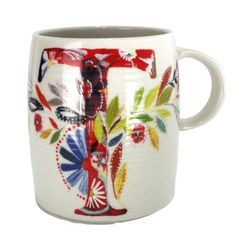 a white coffee cup with colorful designs on it