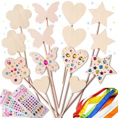 a bunch of wooden sticks with different designs on them and some stick markers in the shape of hearts