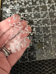 a hand holding a piece of puzzle in it's palm