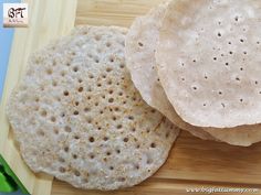 two flat breads on a wooden cutting board