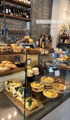 an assortment of breads and pastries on display in a bakery