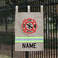 a fire department sign hanging on a fence