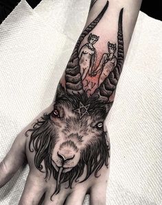 a hand with an animal tattoo on it