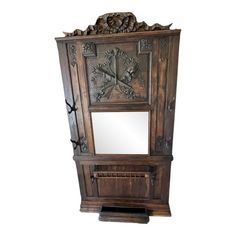 an ornate wooden cabinet with mirror on top