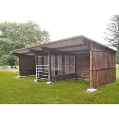 a small wooden building with a ladder to the top of it's roof and windows