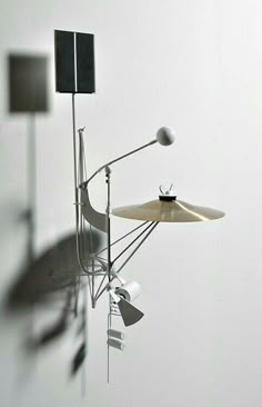 a musical instrument is suspended in the air by two lamps and a light bulb on top