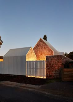 a brick building with a white fence around it