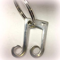 a pair of metal scissors sitting on top of a white table next to each other