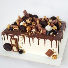 a cake with chocolate and cookies on top