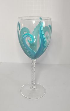 a wine glass with an octopus painted on it