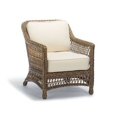 a wicker chair with yellow cushions on a white background