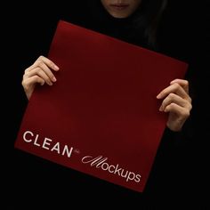 a woman holding up a red sign that says clean mocks