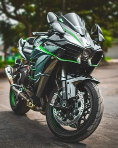 a black and green motorcycle parked on the street