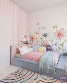 a child's bedroom decorated in pastel colors with flowers on the wall and bed