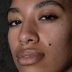 a woman with nose piercings on her nose