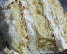 a close up of a piece of cake on a plate with a fork next to it